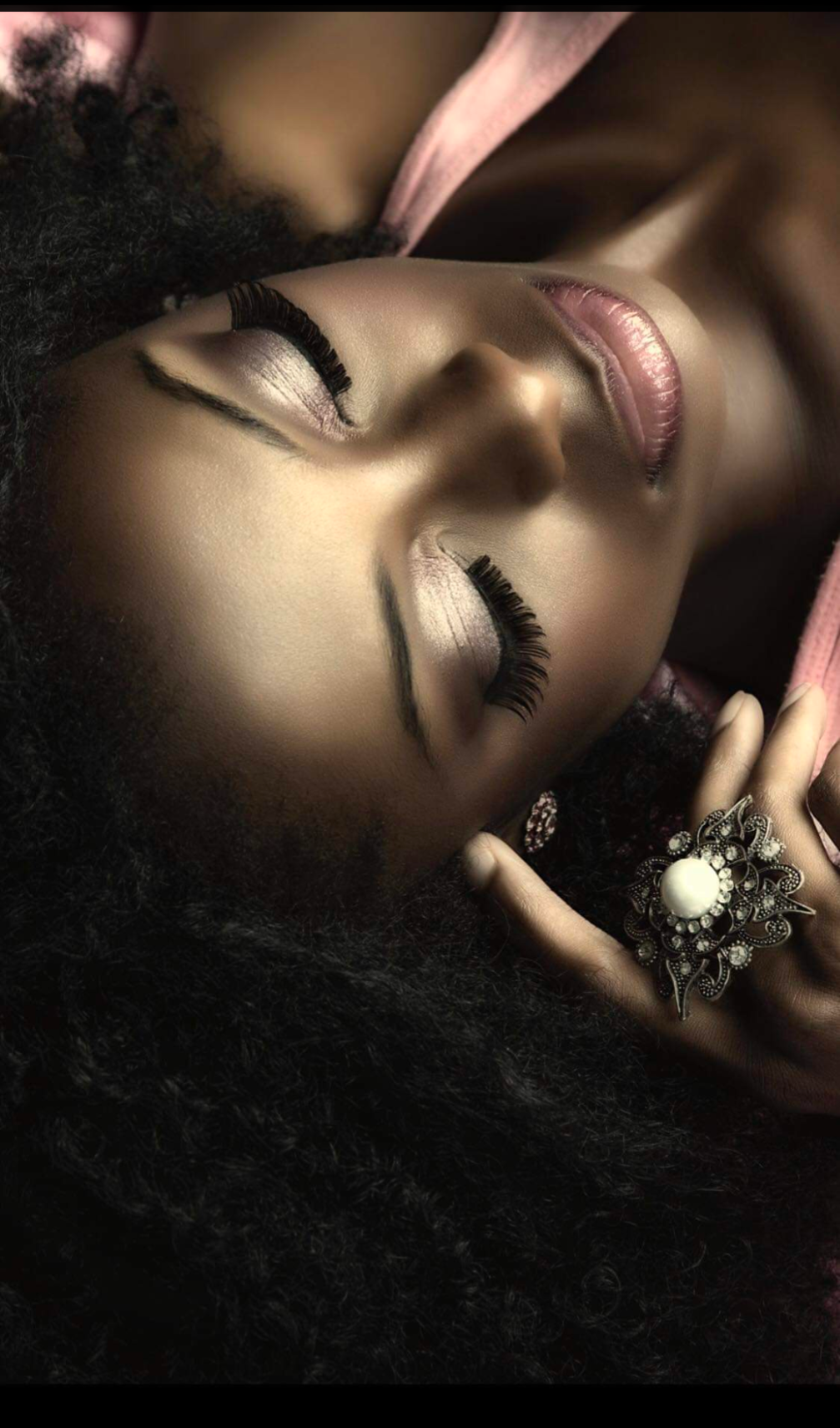 A woman with a ring on her finger is laying down