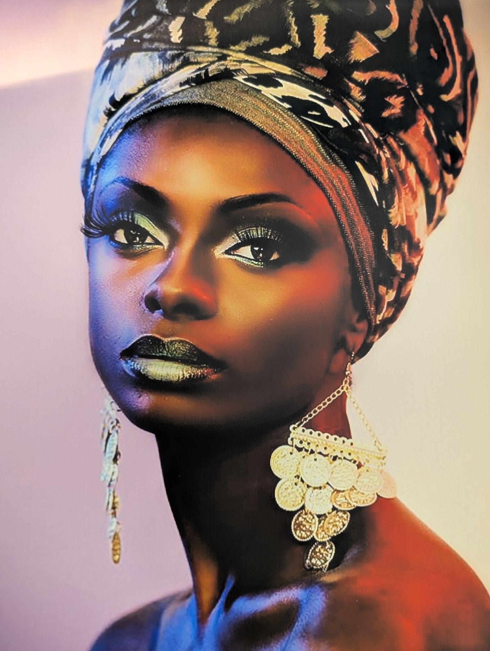 A close up of a woman wearing a turban and earrings