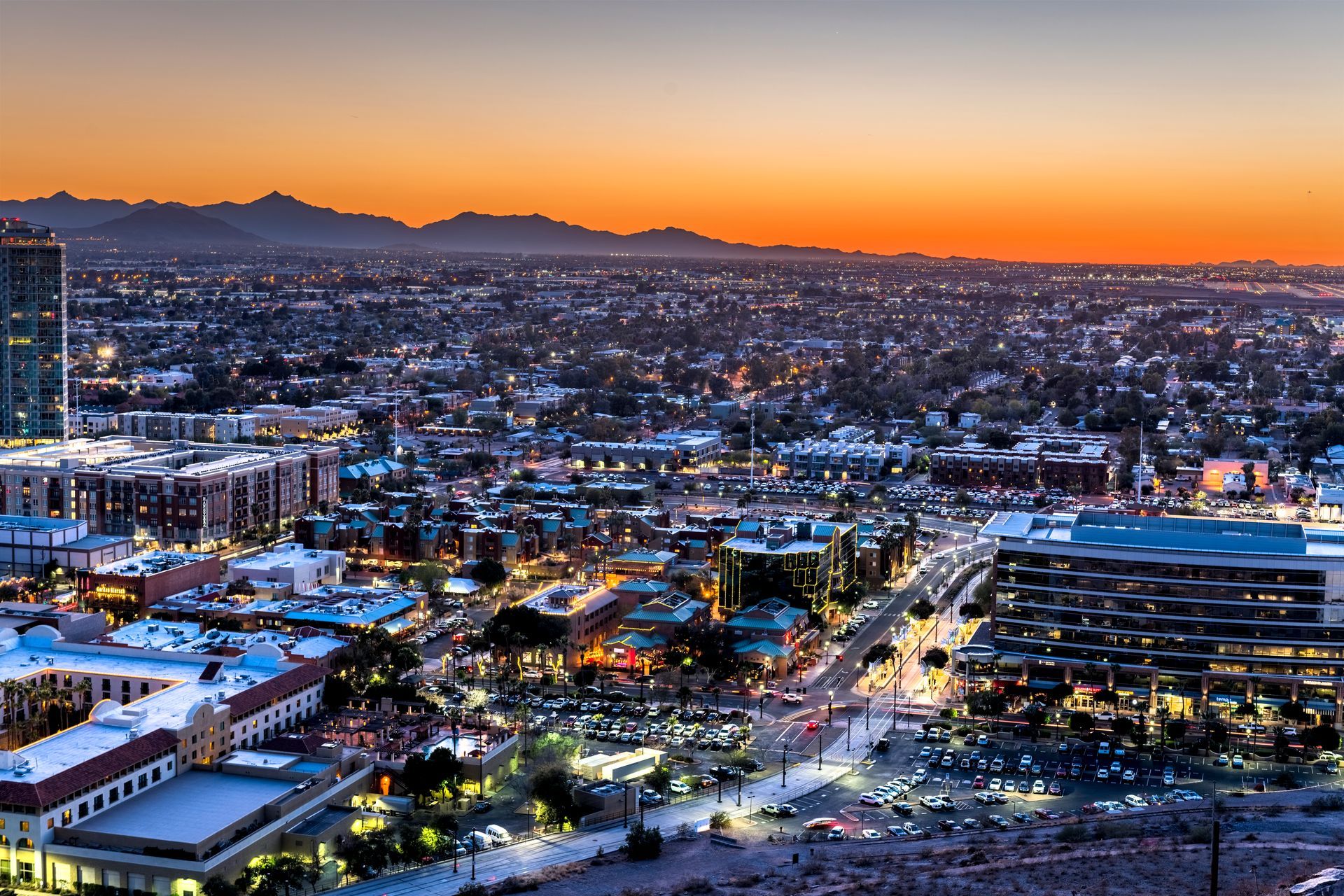 A man in a suit and tie is standing with his hands in his pockets.