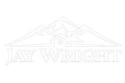 A white logo featuring mountain peaks behind a house outline above the text 