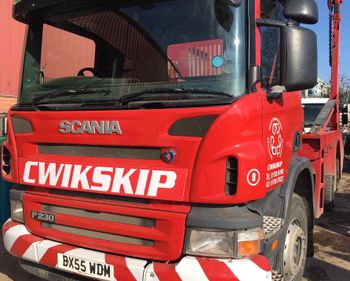 lorries carrying skips on a road