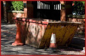 For waste management services in Coventry call 01788 541 066 street with yellow skip traffic cones around it