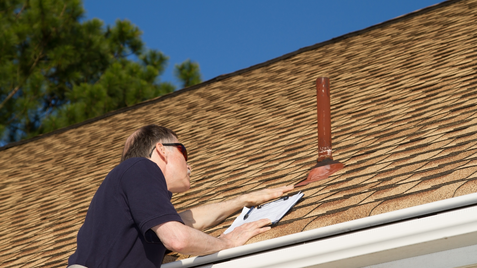 Roofing contractor performing roof inspection