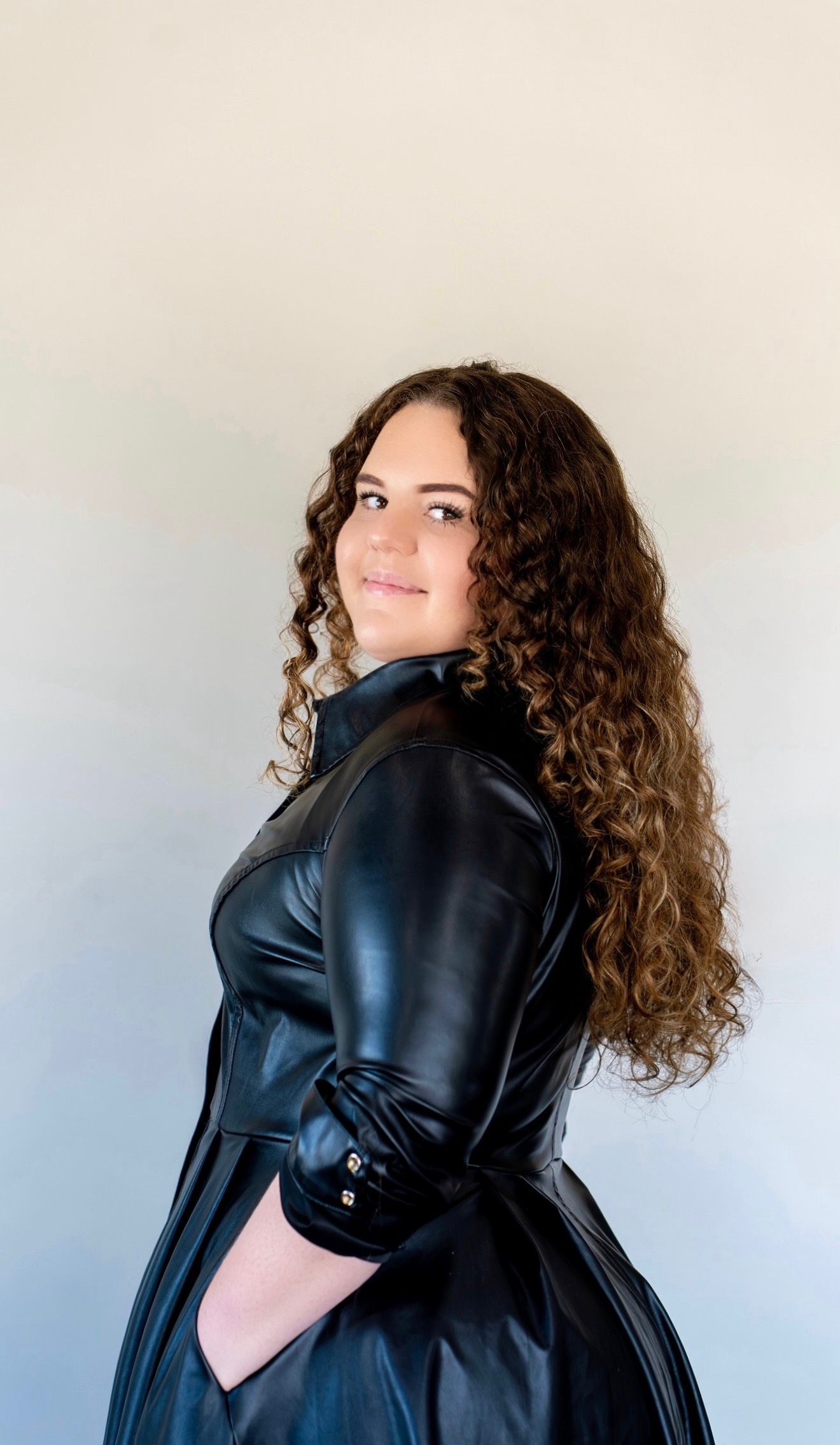 Black and white close-up of hair cutting shears hanging on a rack.
