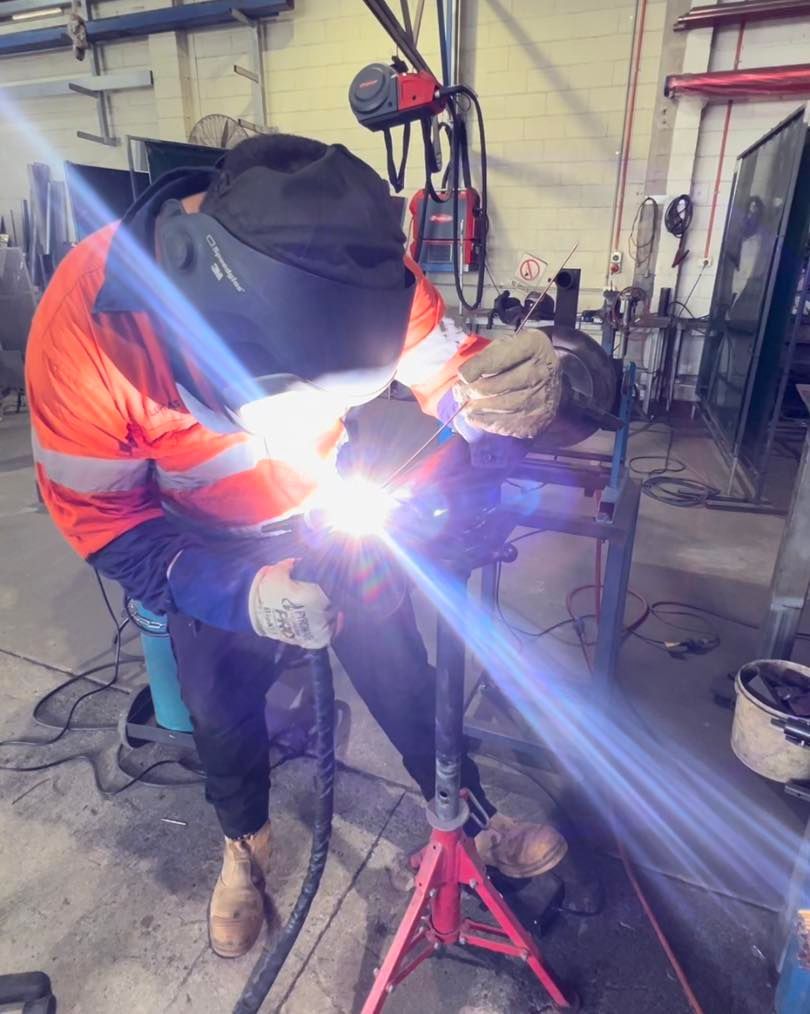 Welder Wearing Protective Gear, Welding Metal In A Workshop.