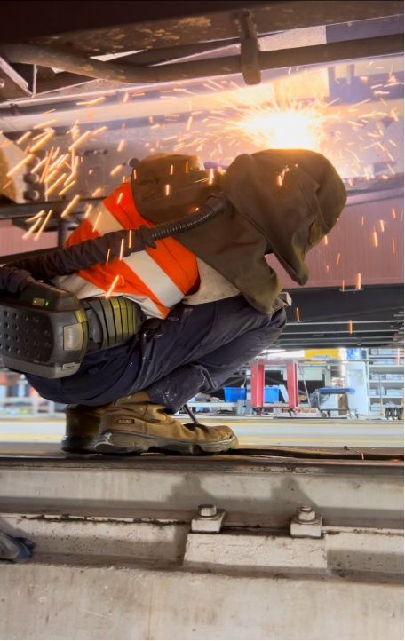 A Man Is Welding A Piece Of Metal In A Factory — Hanby Welding & Engineering In Portsmith, QLD