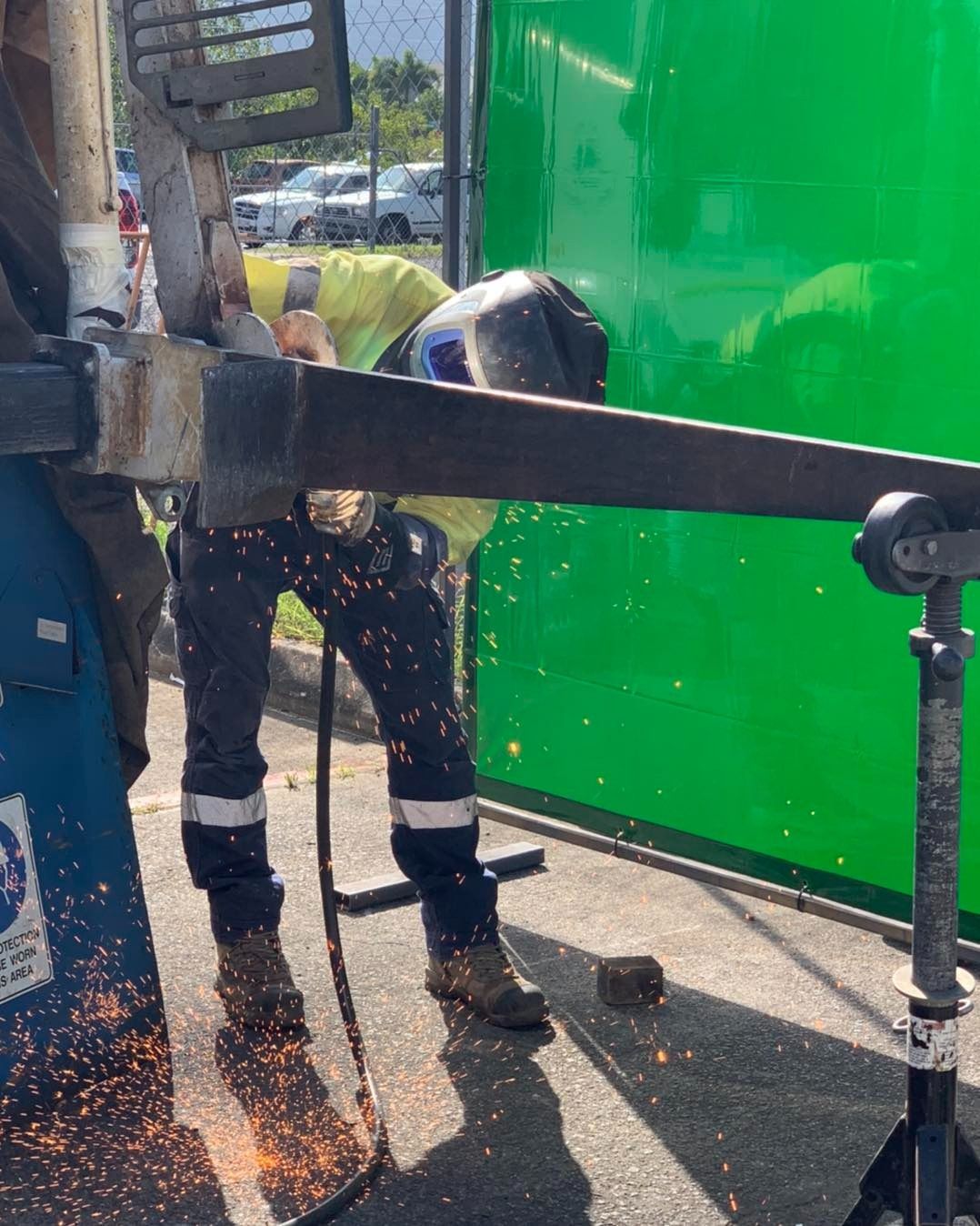 Welder in Protective Gear Works on Metal