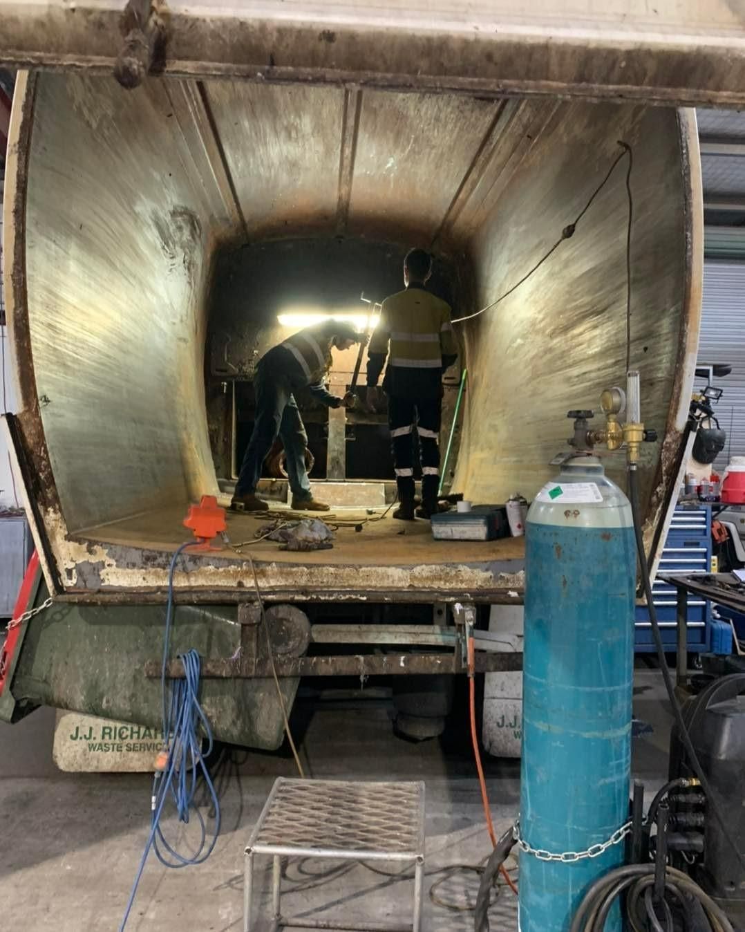 A Garbage Truck Is Being Worked On In A Garage — Hanby Welding & Engineering In Portsmith, QLD