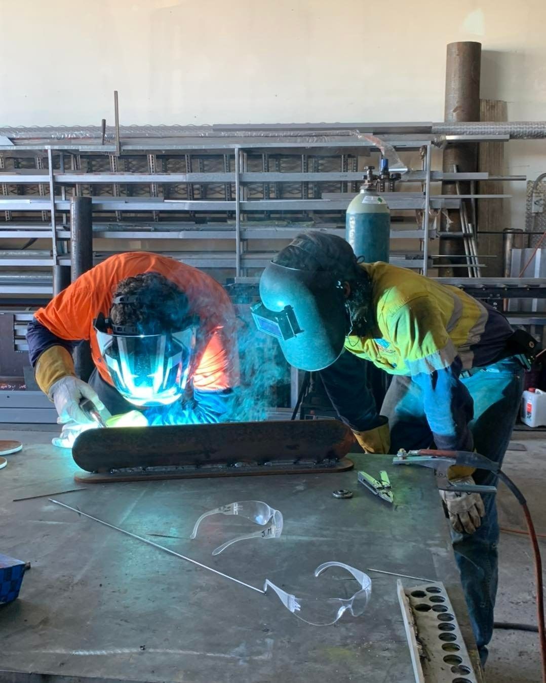 Two Men Are Welding A Piece Of Metal In A Factory — Hanby Welding & Engineering In Portsmith, QLD
