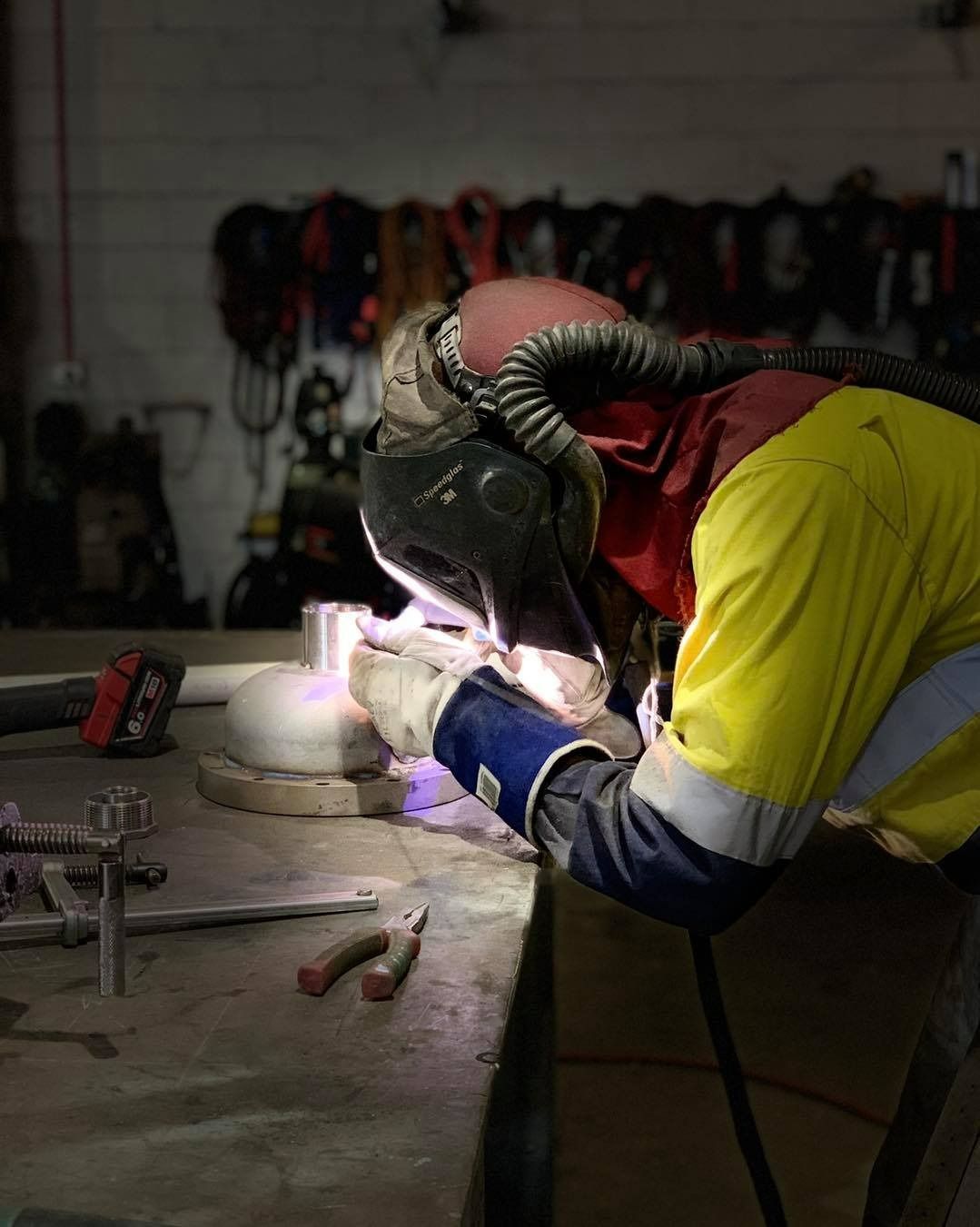 A Man Is Welding A Piece Of Metal In A Workshop — Hanby Welding & Engineering In Portsmith, QLD