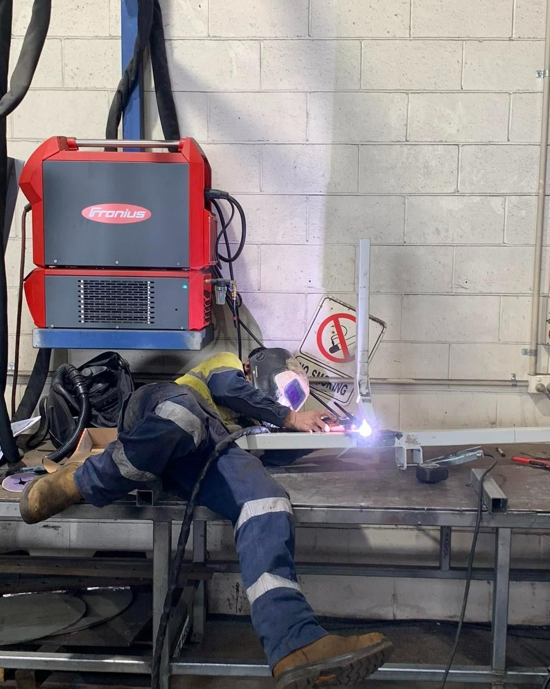 A Man Is Welding A Piece Of Metal In A Factory — Hanby Welding & Engineering In Portsmith, QLD