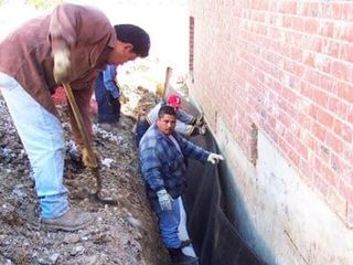 worker working on foundation - foundation repair and inspection in Garland, TX