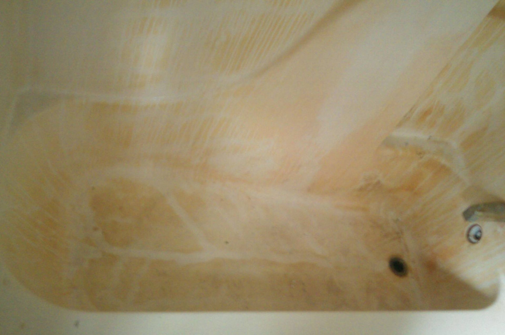 A close up of a bathtub with soap coming out of it