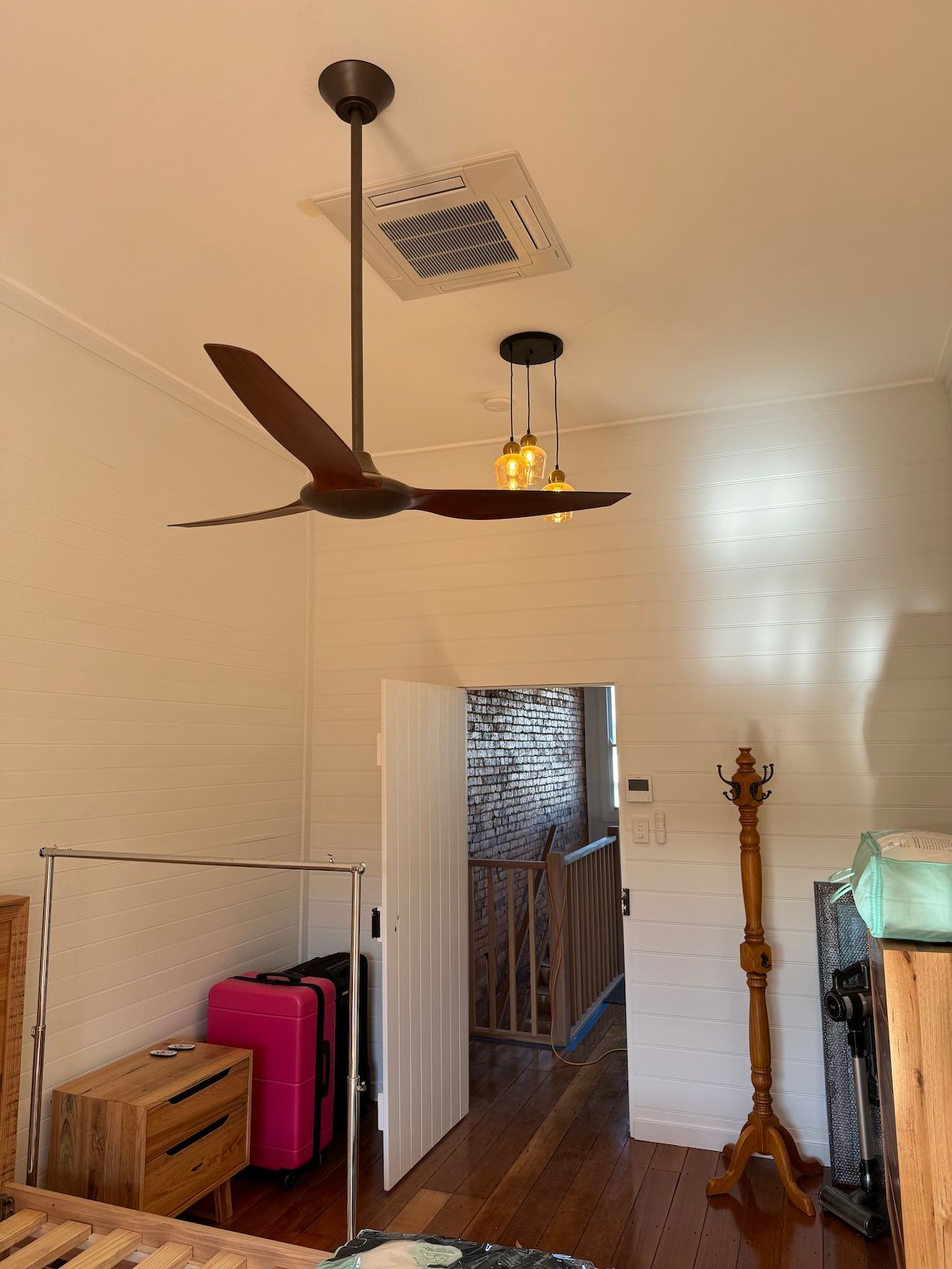 A White Air Conditioner Is Mounted To The Ceiling Of A Room — Coolmech In Gympie, QLD