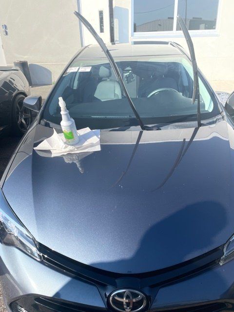 A toyota car with a spray bottle on the hood