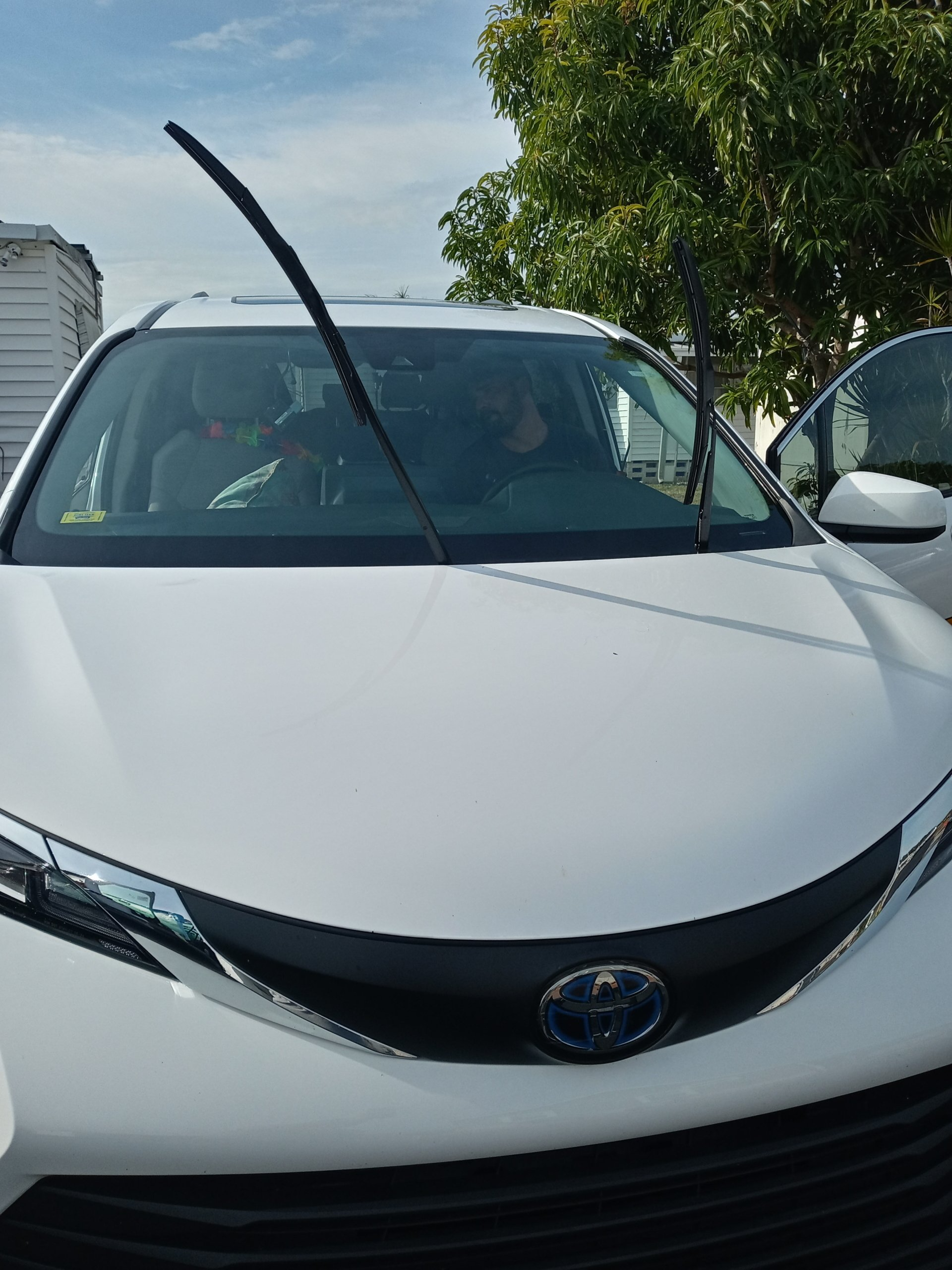 A white car with a windshield wiper on it