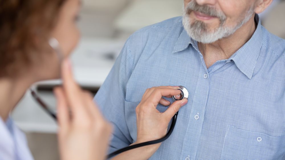 Doctor listening to a patient's chest with a stethoscope.