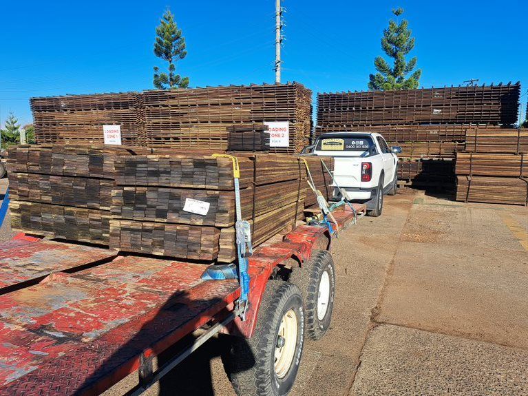 A truck is pulling a trailer full of wooden crates.