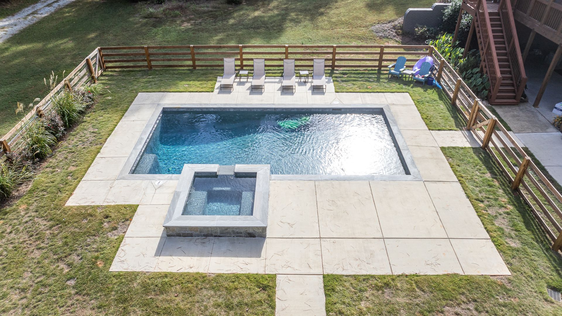 An aerial view of a large swimming pool in a backyard