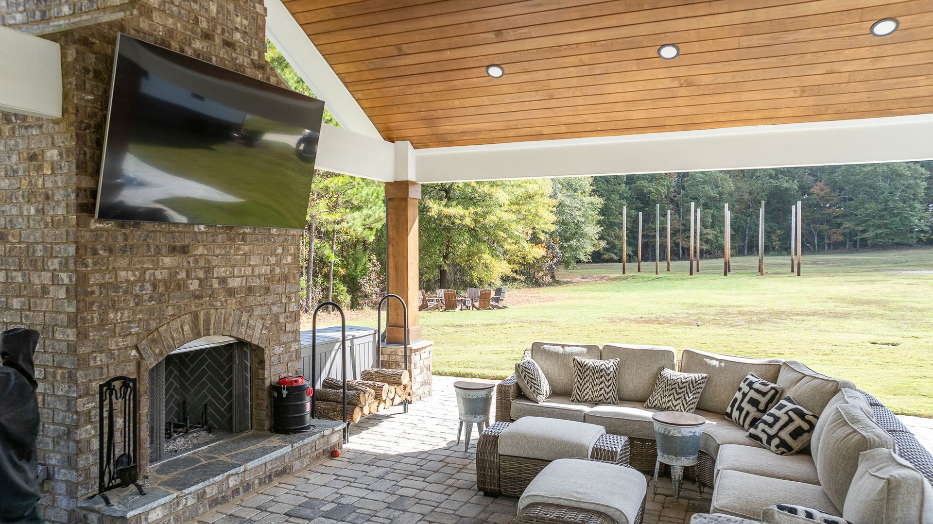 A living room with a fireplace and a flat screen tv.