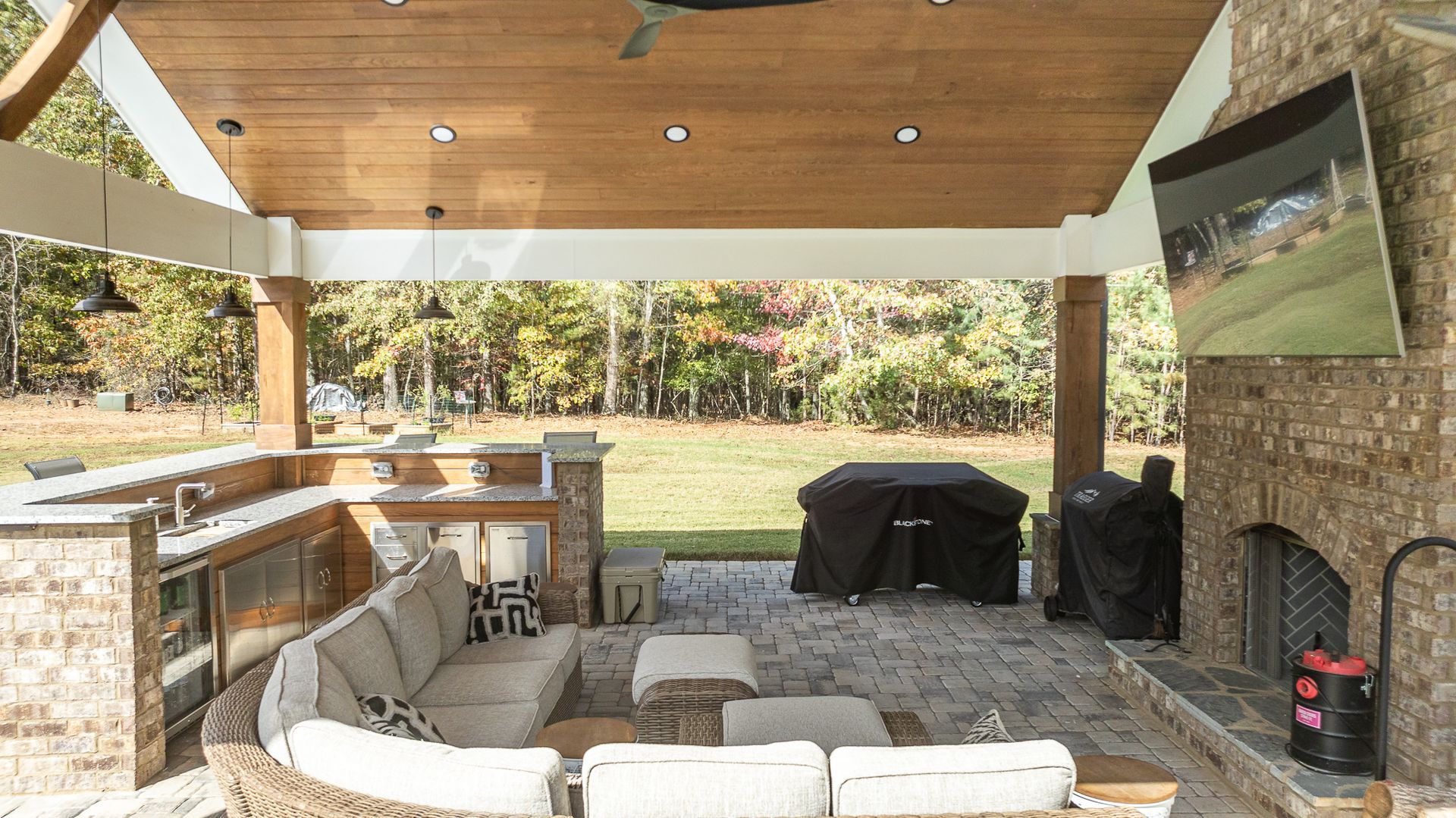 A living room with a couch , fireplace and television