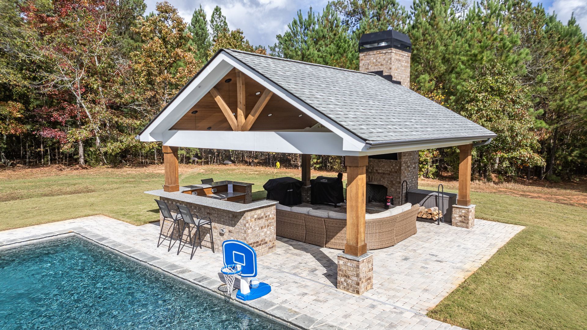 There is a pool with a pavilion in the middle of it.