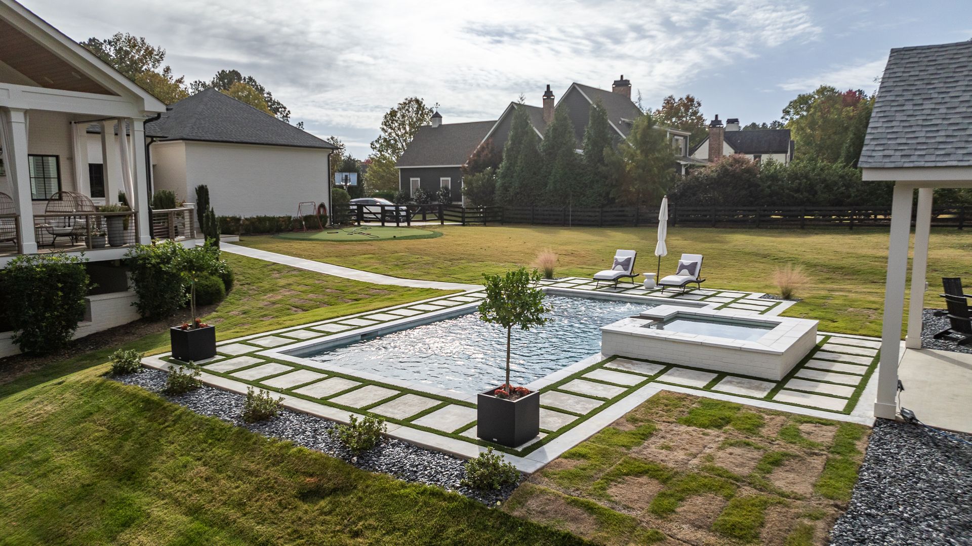 A large swimming pool in the backyard of a house.