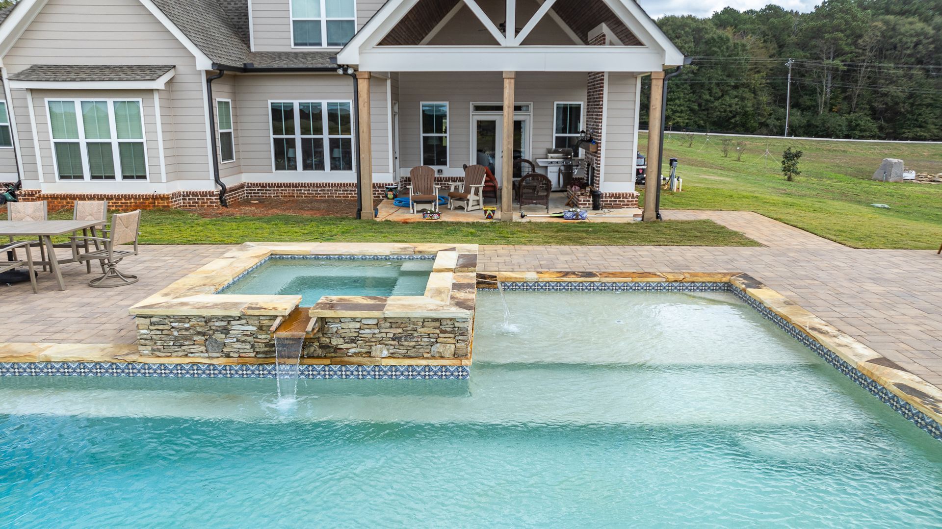 A large house with a swimming pool in front of it.
