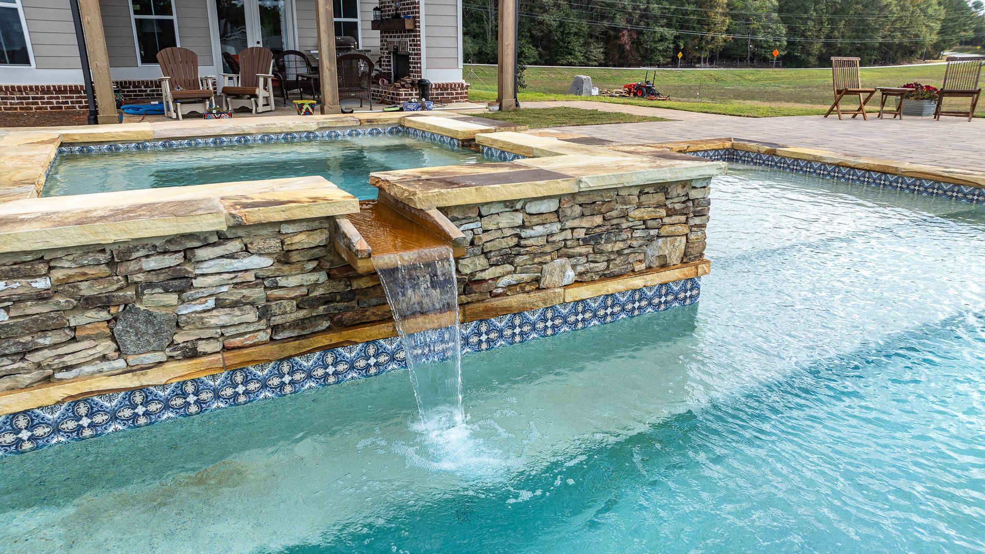 There is a waterfall in the middle of the pool.