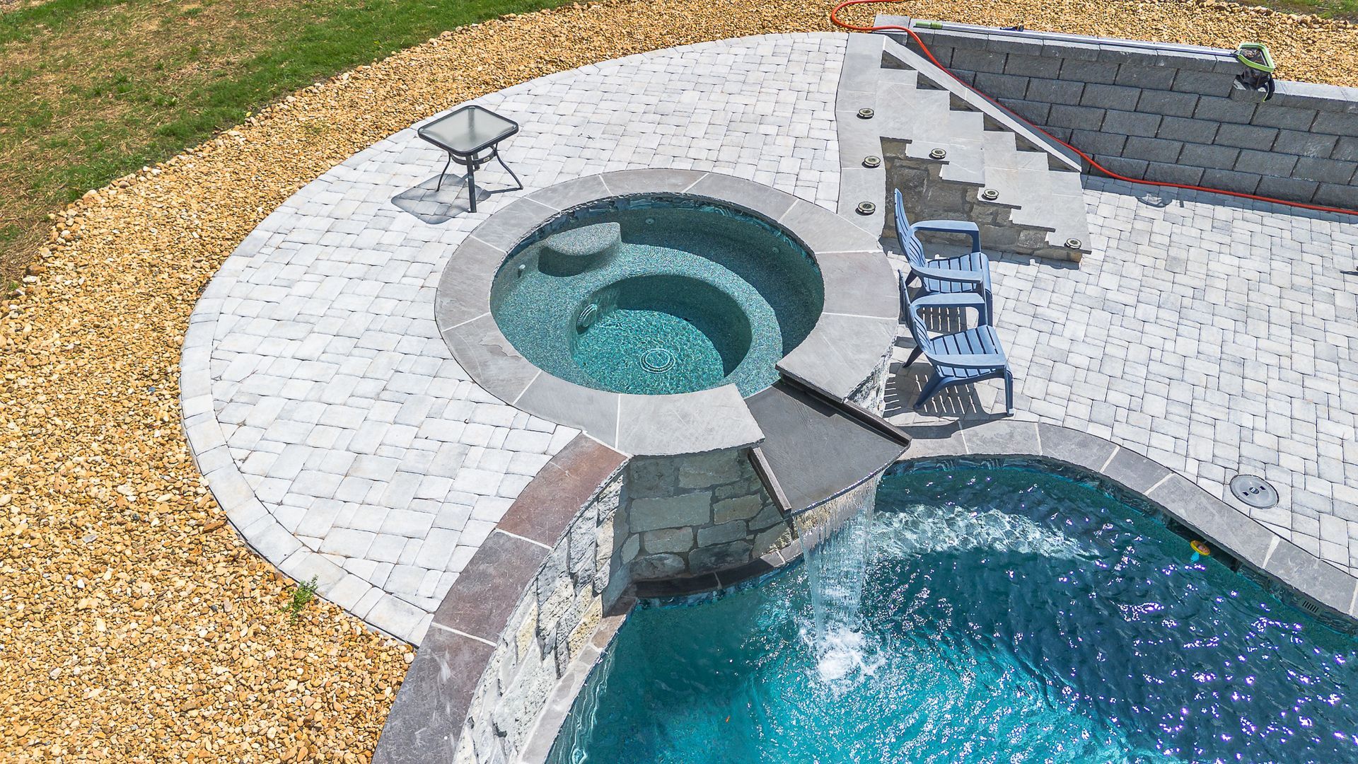 An aerial view of a house with a large swimming pool