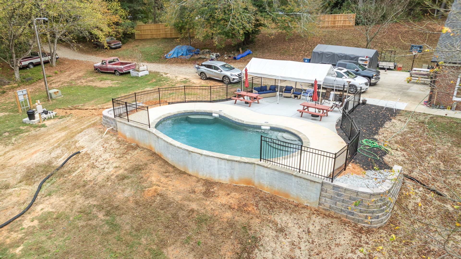 An aerial view of a large swimming pool in a yard.