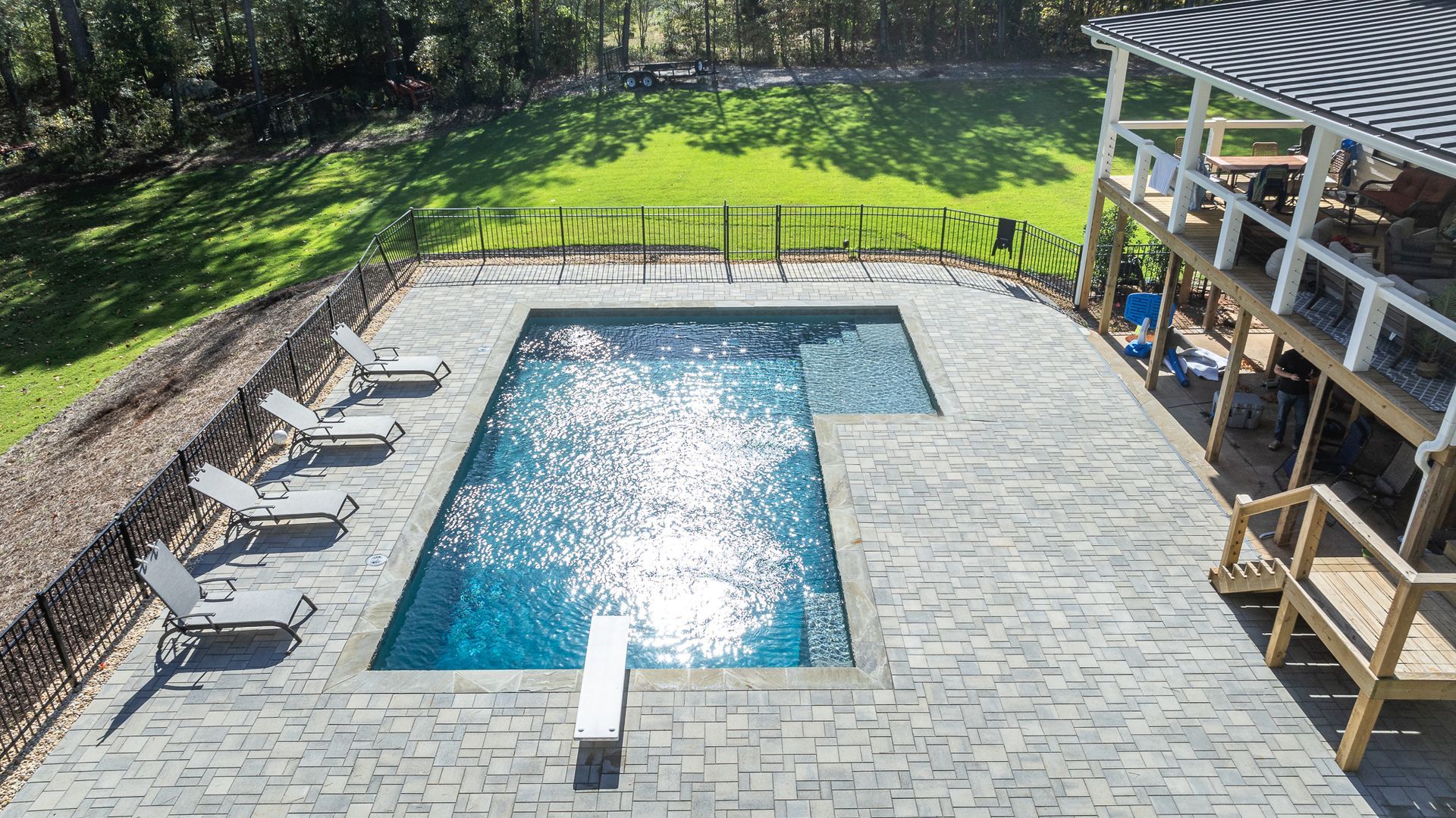 An aerial view of a large swimming pool surrounded by chairs.