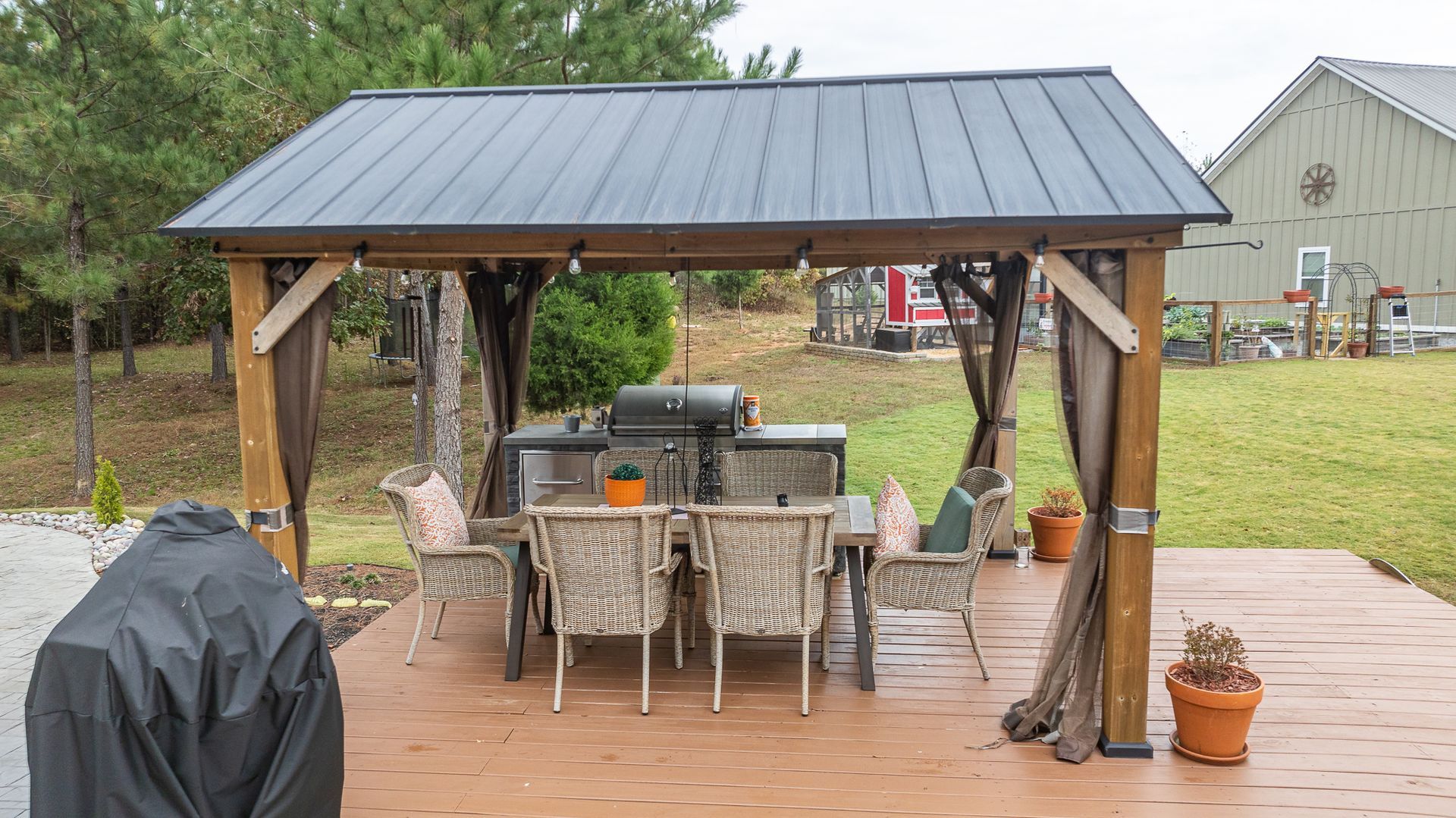 There is a gazebo with a table and chairs underneath it.