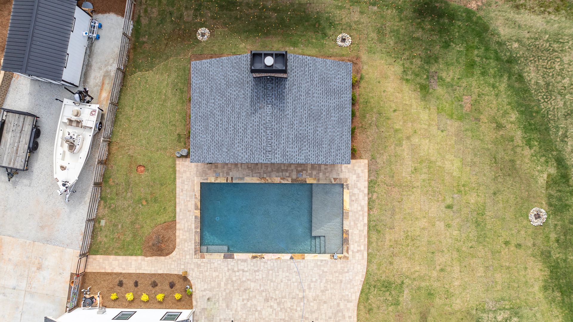 An aerial view of a house with a pool in the backyard.