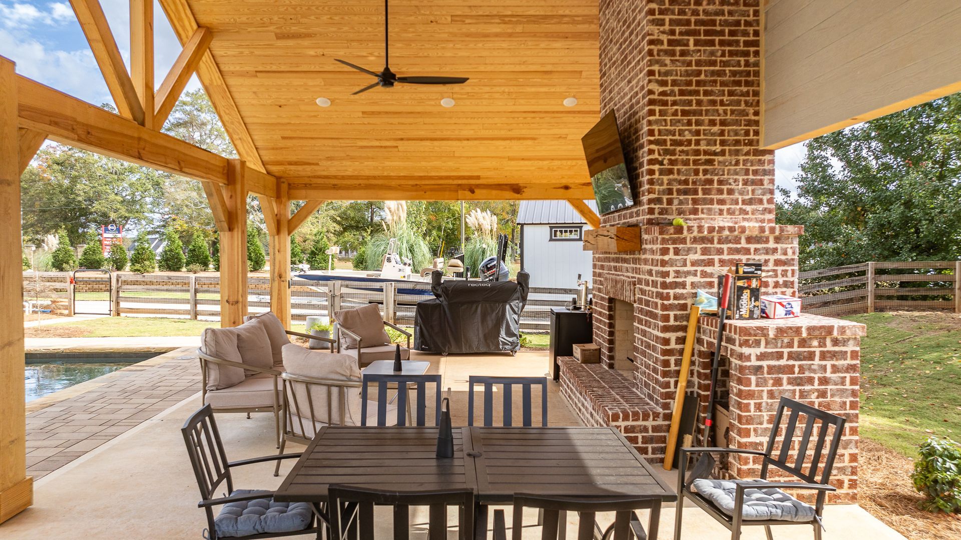 A patio with a table and chairs and a fireplace.