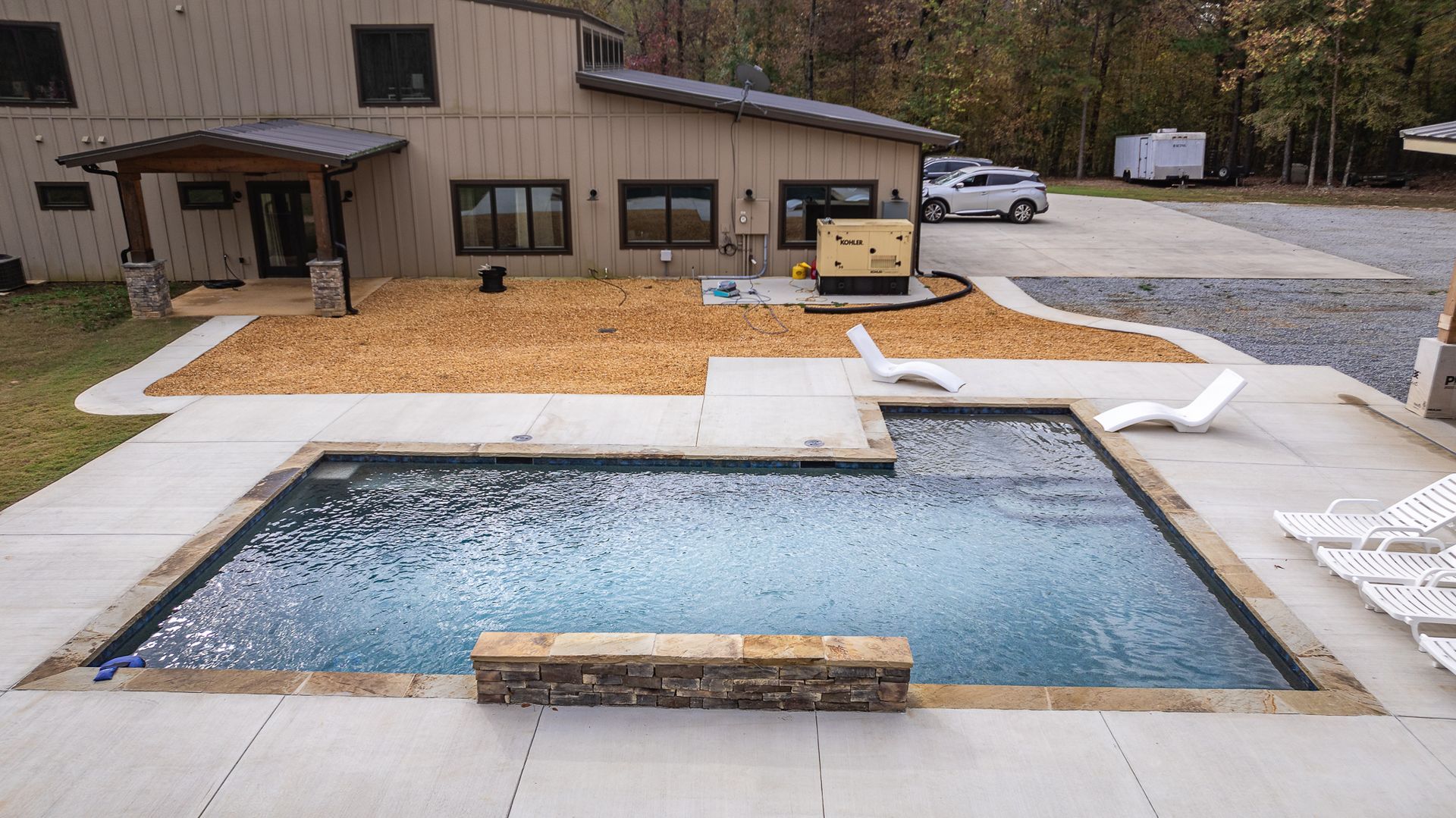 A large house with a swimming pool in front of it