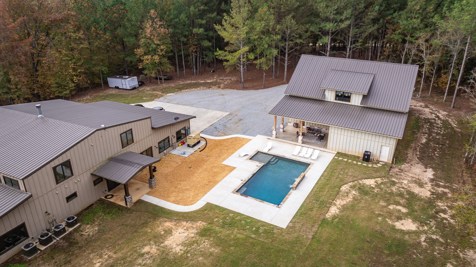 An aerial view of a house with a pool in the backyard.