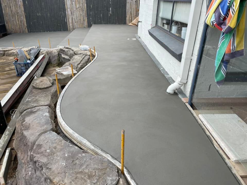 A Concrete Walkway Is Being Built in Front of A House — J’s Concreting & Carpentry in Wauchope, NSW