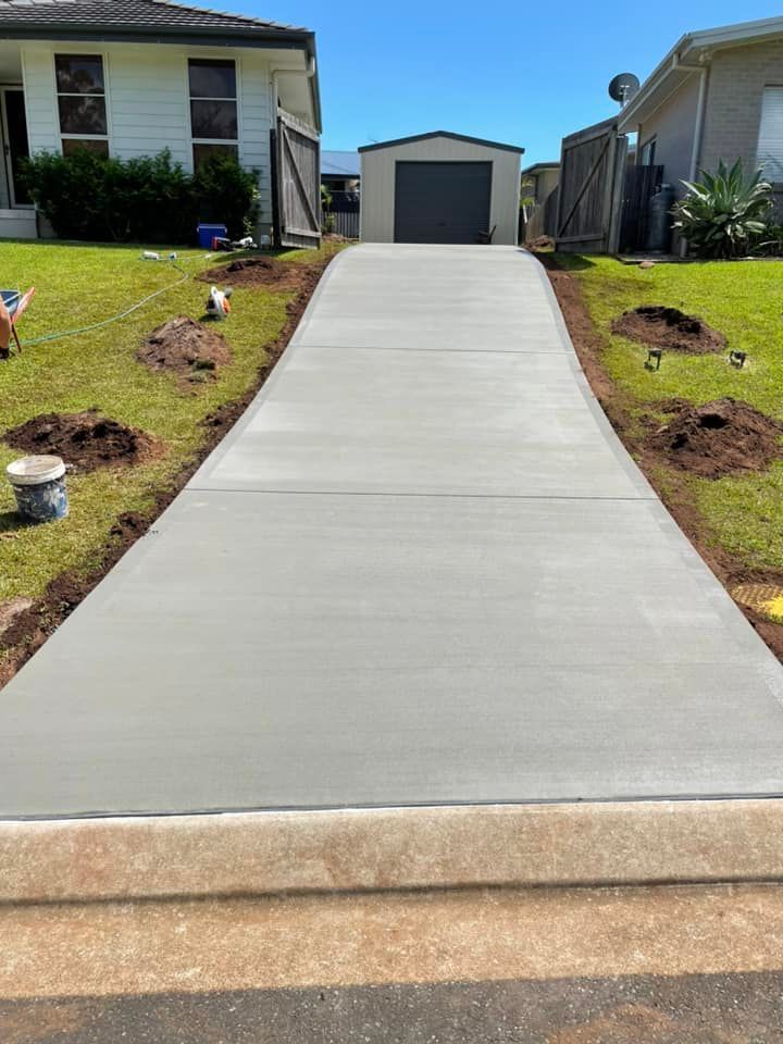A Concrete Driveway Is Being Built in Front of A House — J’s Concreting & Carpentry in Port Macquarie, NSW