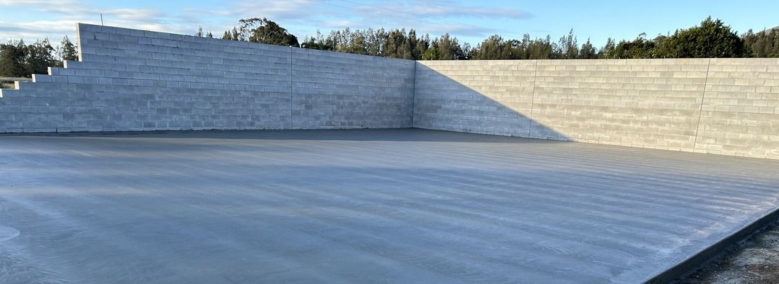 A Concrete Driveway Is Being Built in Front of A Building — J’s Concreting & Carpentry in Kew, NSW