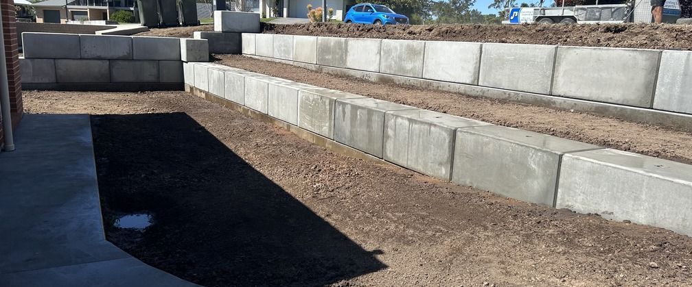 A Wooden Wall Is Being Built Next to A Brick Wall — J’s Concreting & Carpentry in Kew, NSW