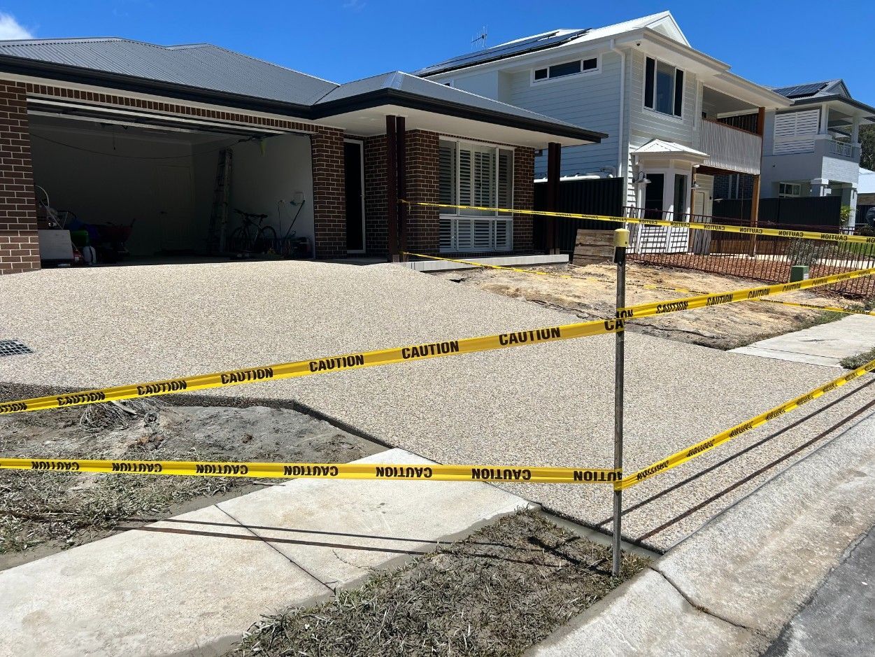 There Is a Large Swimming Pool in The Backyard of A House — J’s Concreting & Carpentry in Kew, NSW