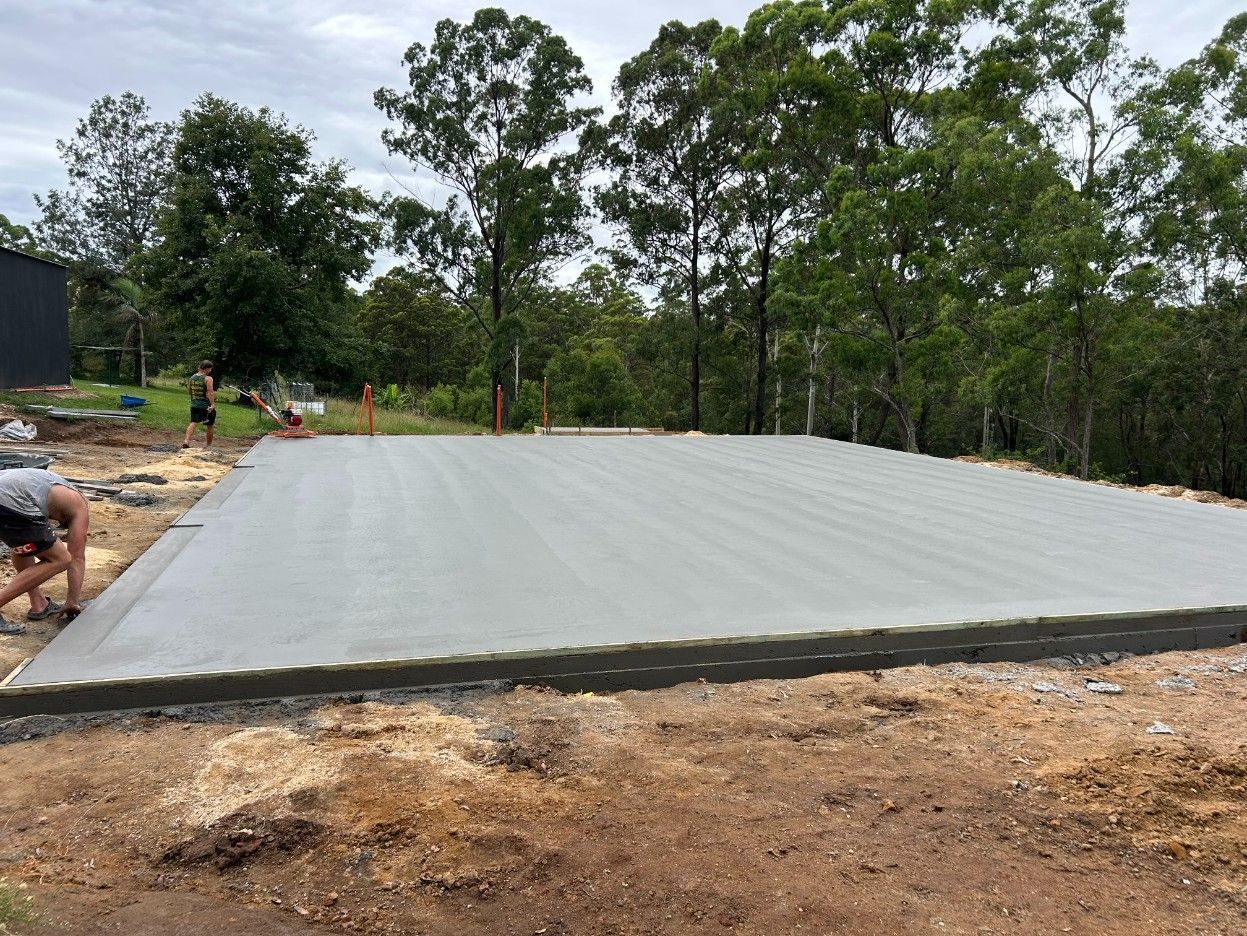 A Wooden Wall Is Being Built Next to A Brick Wall — J’s Concreting & Carpentry in Kew, NSW