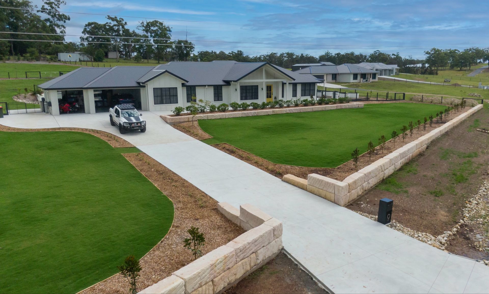A Concrete Driveway Is Being Built in Front of A House — J’s Concreting & Carpentry in Kew, NSW