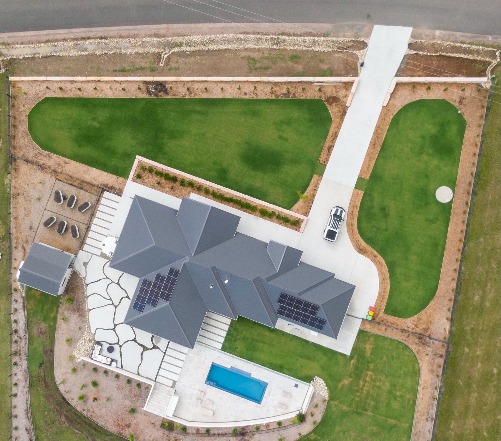 A Brick Wall Is Being Built Next to A Concrete Slab — J’s Concreting & Carpentry in Kew, NSW