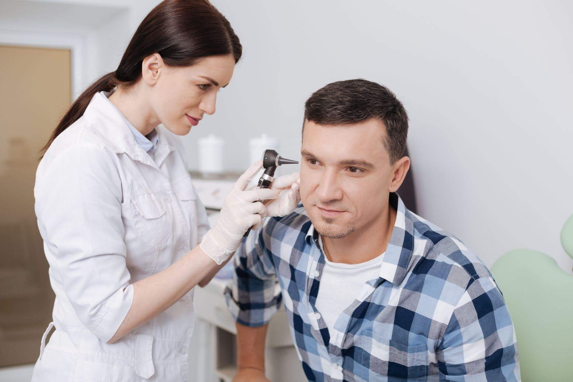 man receiving hearing exam from registered audiologist