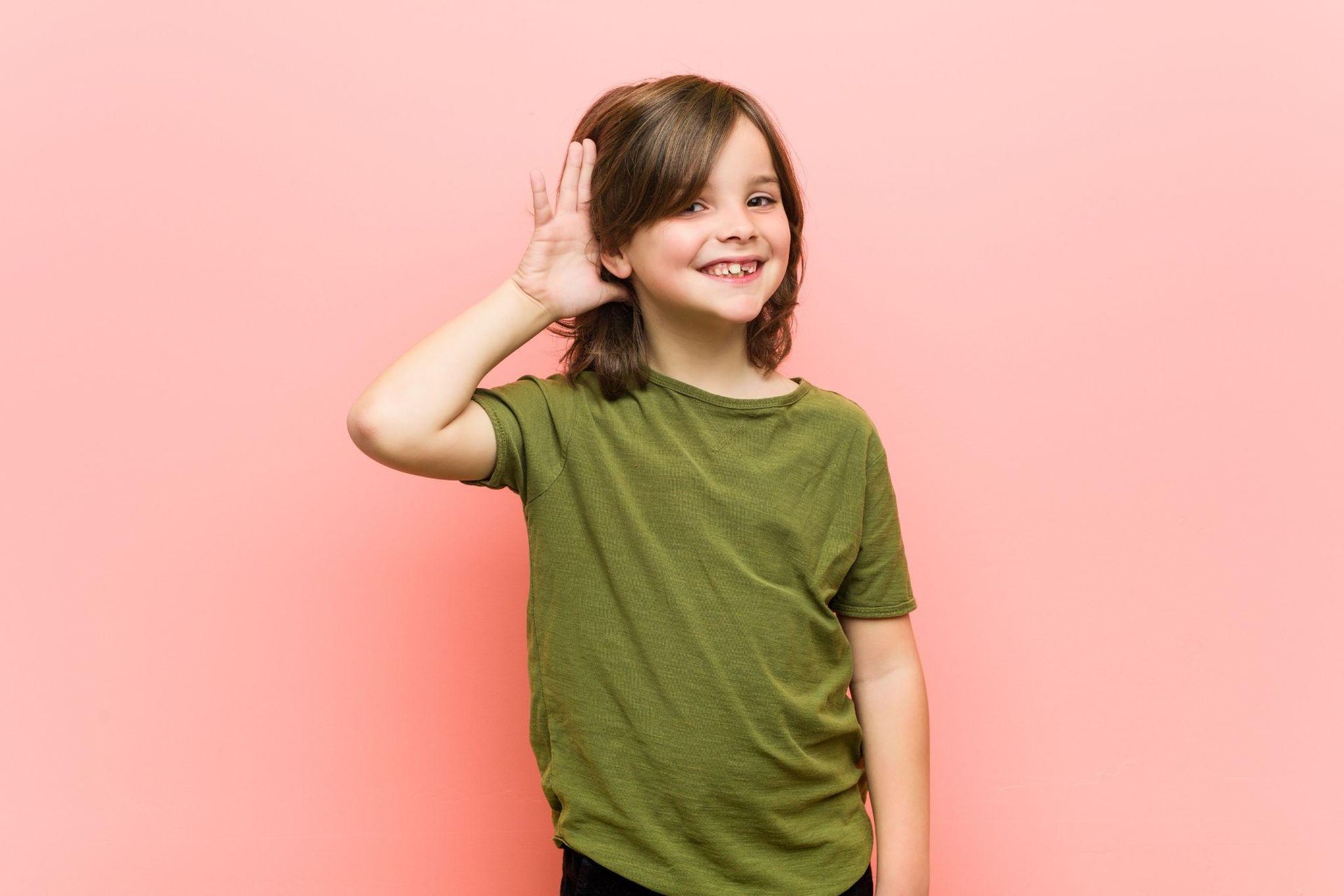 child with hand cupped to ear