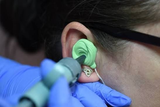 woman getting custom earplug