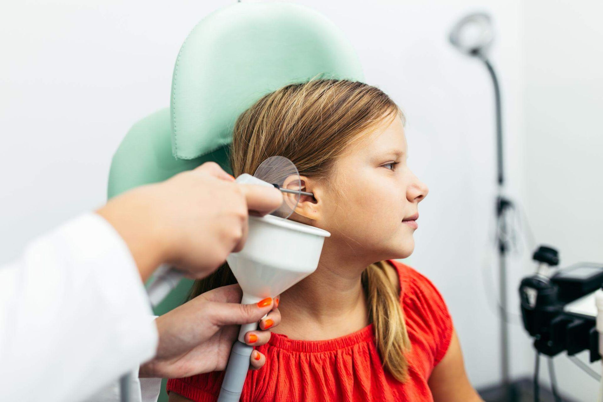 girl receiving professional cerumen removal.