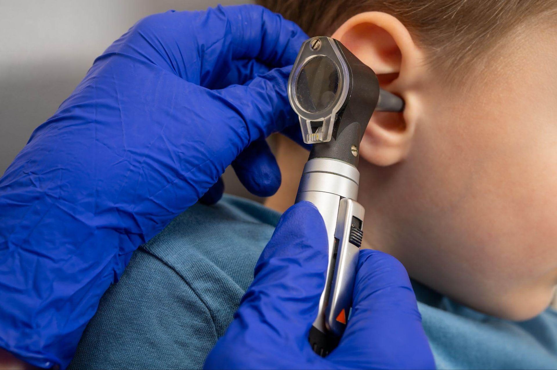 child receiving a professional ear examination